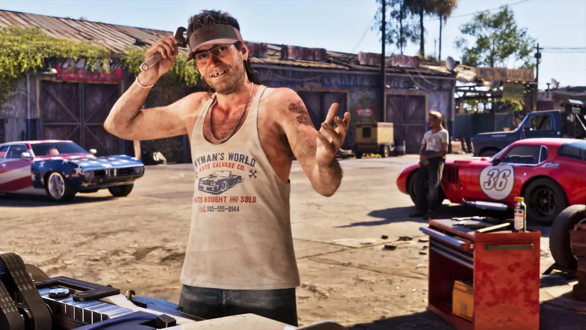 A man in a headband and Wyman's tank top waving in a salvage yard full of classic cars, from official Grand Theft Auto VI screenshots.